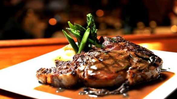 steak with sauce and green vegetables at wolf and lamb