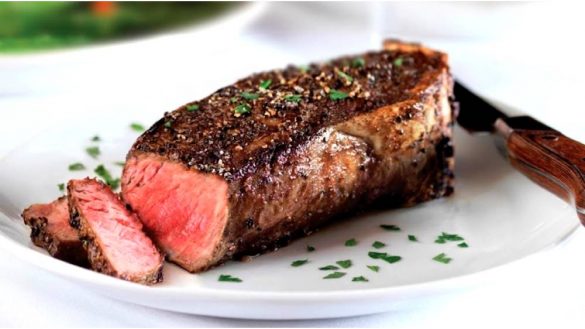 medium-rare steak from bordeaux steakhouse with fresh herbs